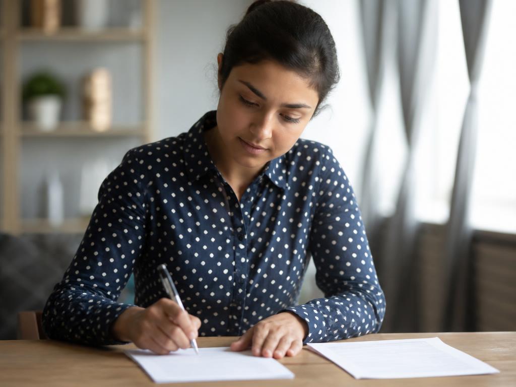 A client reviewing and signing a repayment agreement at a desk
